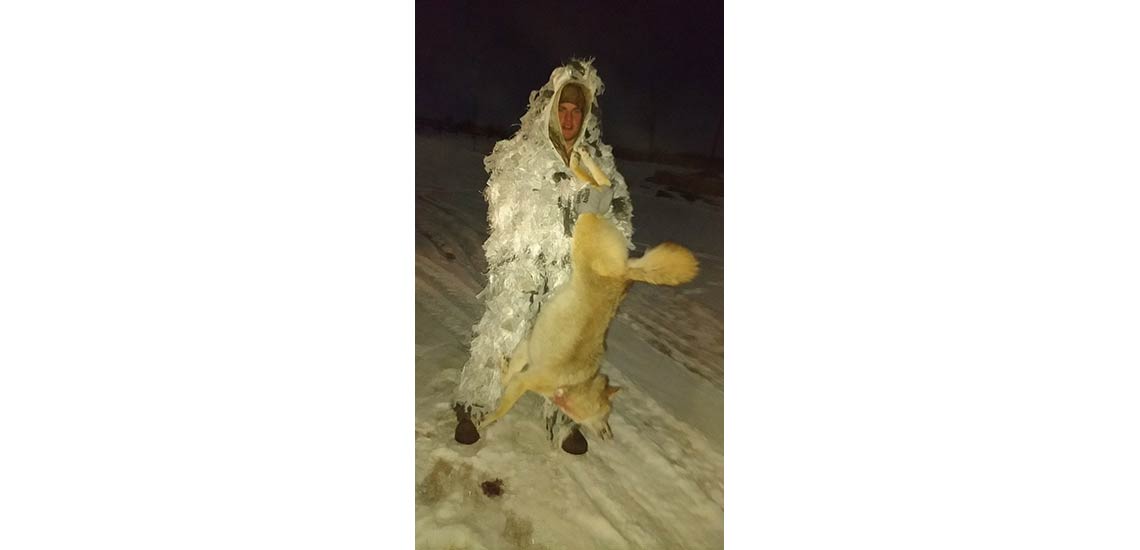 Chase in his snowman suit with what he calls the alpha coyote